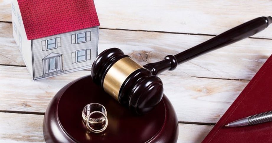home model on top of divorce papers