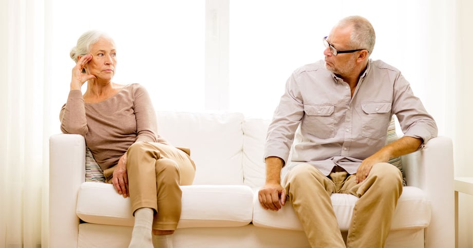 elder couple looking at each other with hate