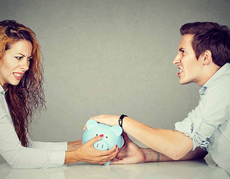 couple fighting over piggy bank