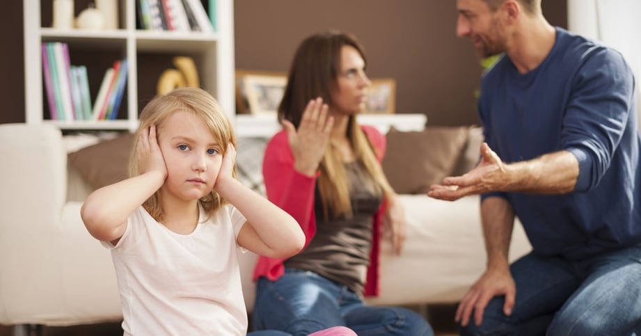 kid covering ears from parents fighting